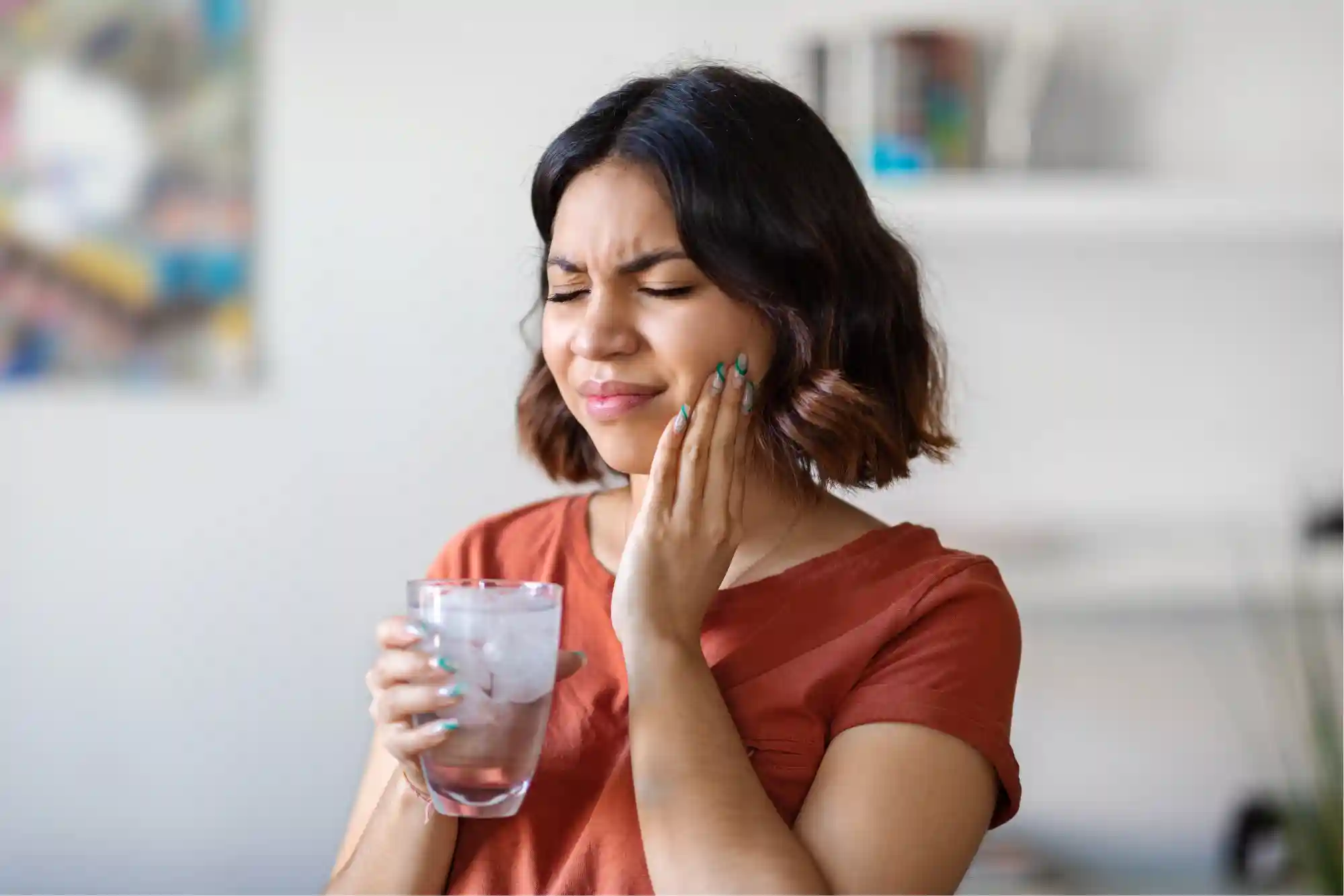 woman holding her jaw because she has tooth pain how to stop sensitive tooth pain rexburg idaho