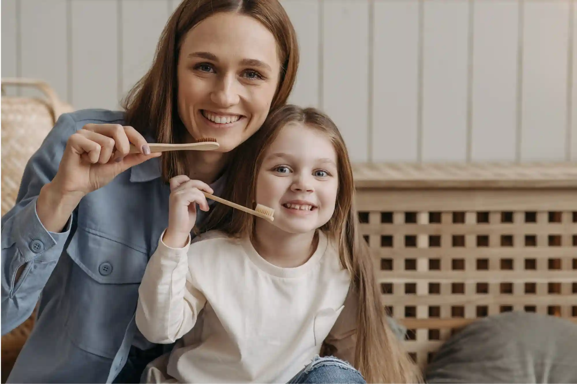 mom and daughter brushing their teeth with soft bristled toothbrush home remedies for sensitive teeth rexburg idaho