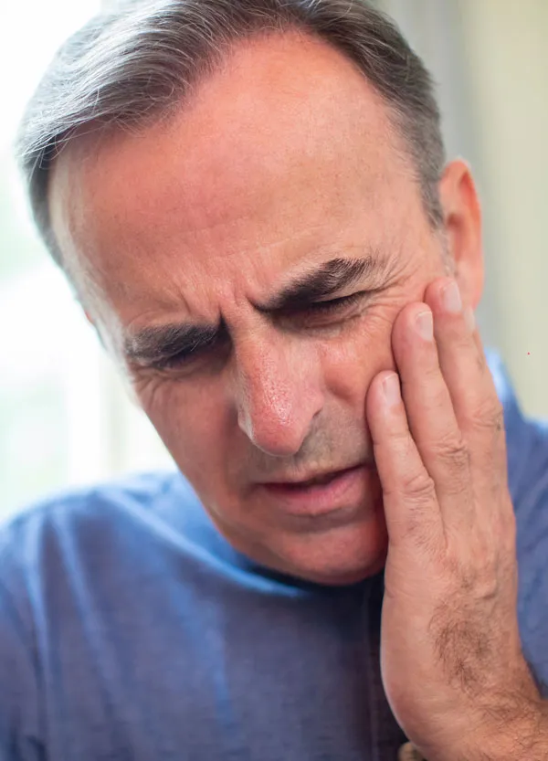 Man in pain representing there is Emergency Dentists ready to help at Strobel Family Dental