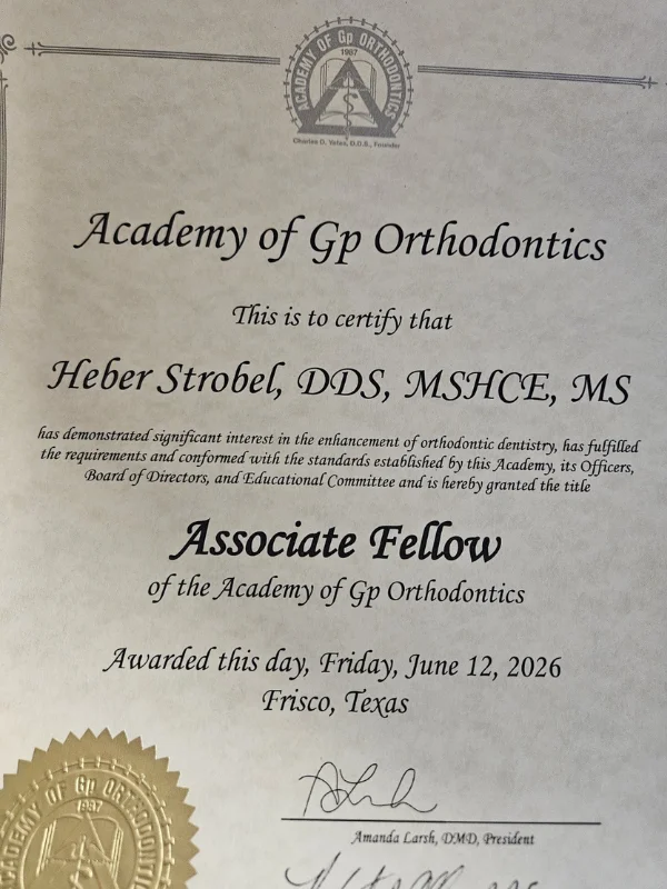 Academy of GP Orthodontics certificate granting Heber Strobel, DDS the title of Associate Fellow, awarded June 12, 2026 in Frisco, Texas.